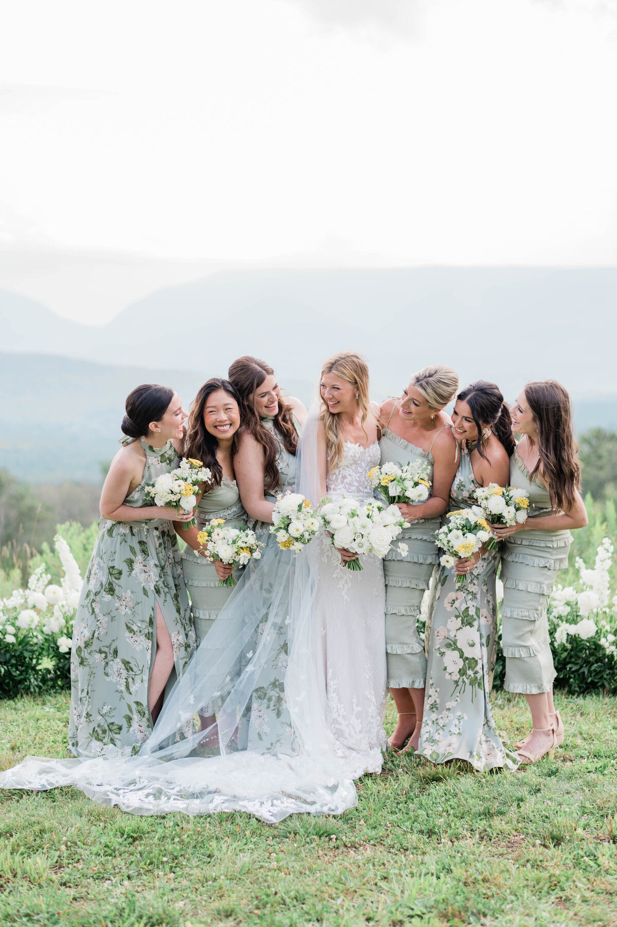 Bridesmaids stand beside the bride in long green gowns