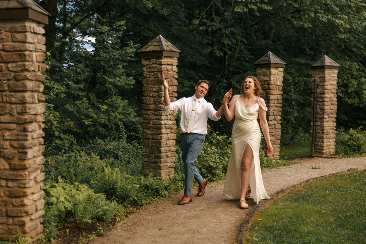 Candid photo of bride and groom walking at sunset for wedding portraits 