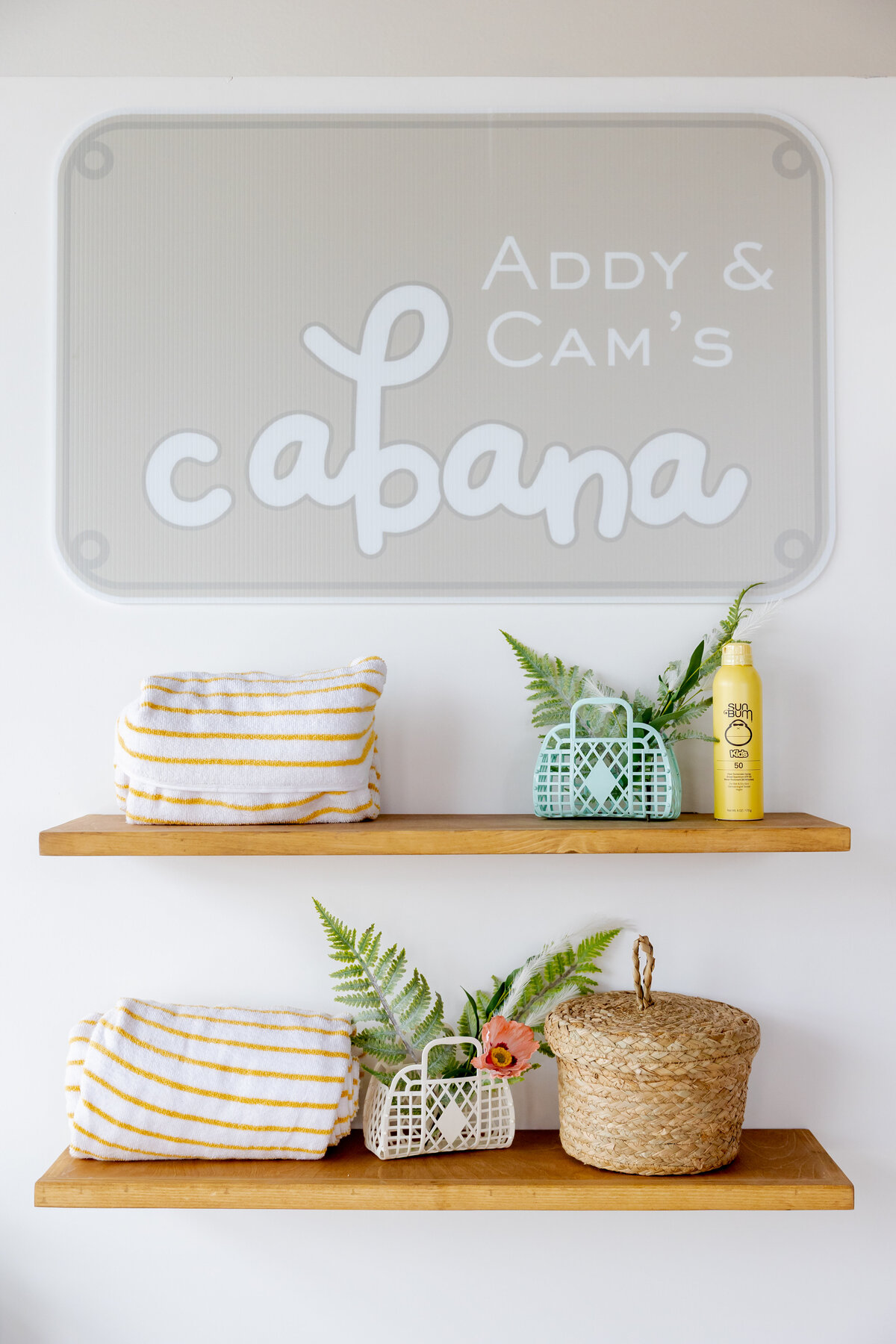 Cutout name sign above decorated pool shelves. 