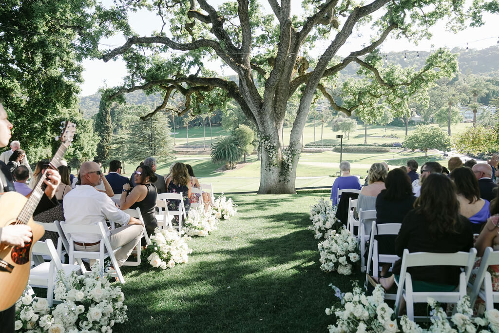 country club wedding, tree ceremony, ground arrangements, white flowers with light blue accents