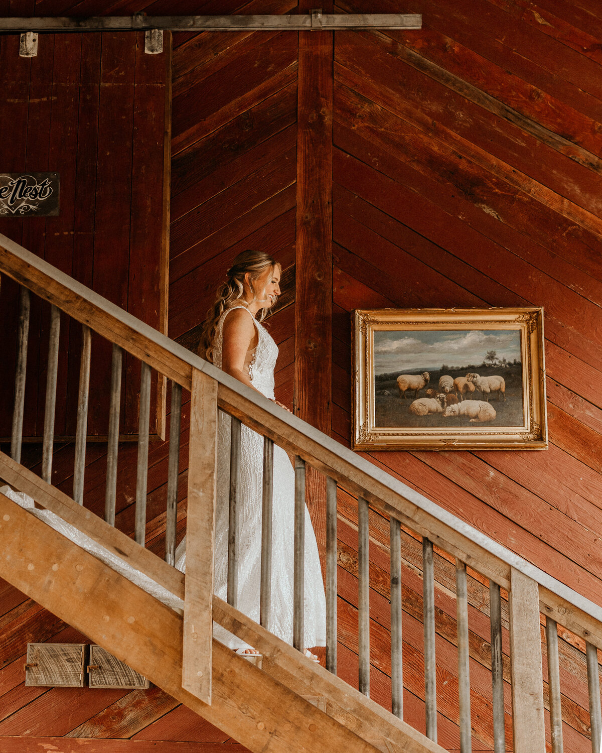 bride smiling and walking down a stair case