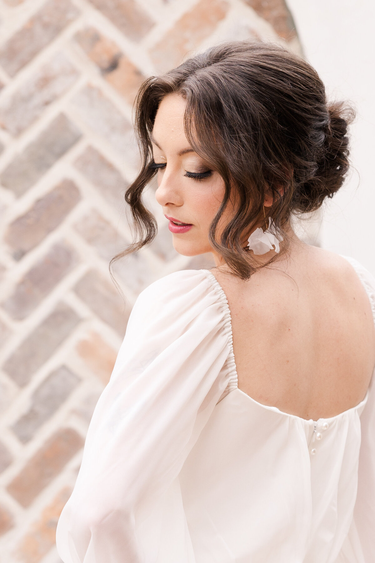 bride-in-ivory-boho-wedding-dress-looking-over-her-shoulder