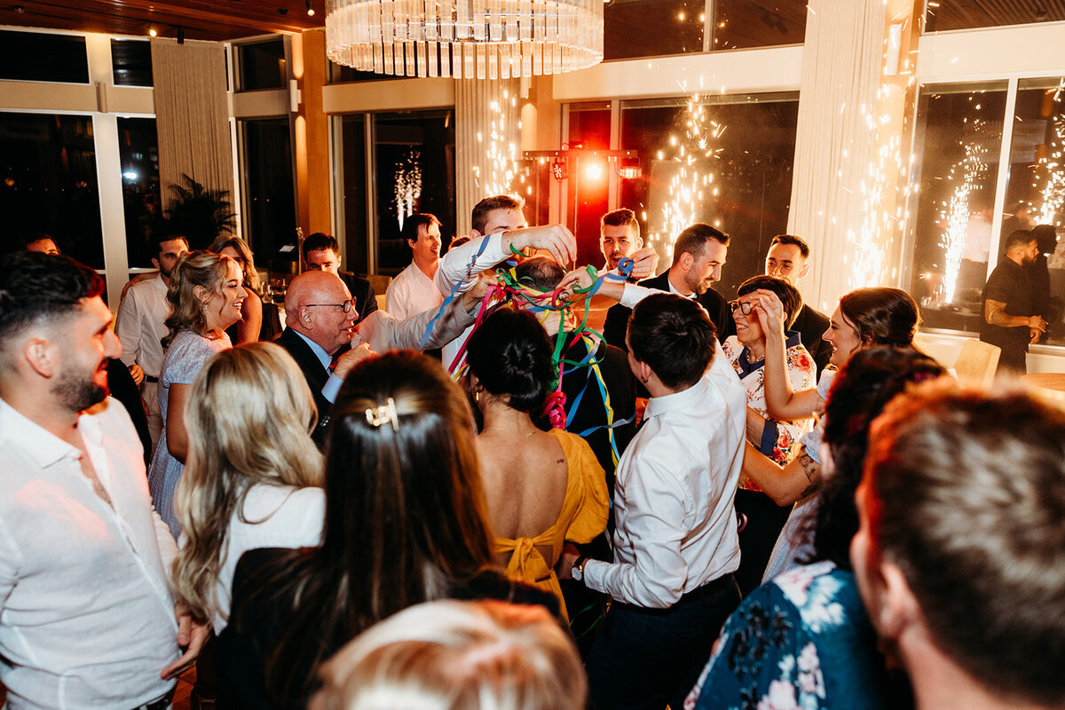 Family and friends shower bride and groom in streamers and confetti after their first dance at The Marion.