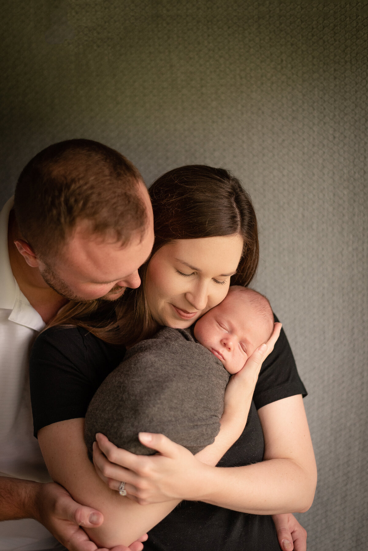 mother father with baby son newborn photographer northeast fort wayne bluffton indiana