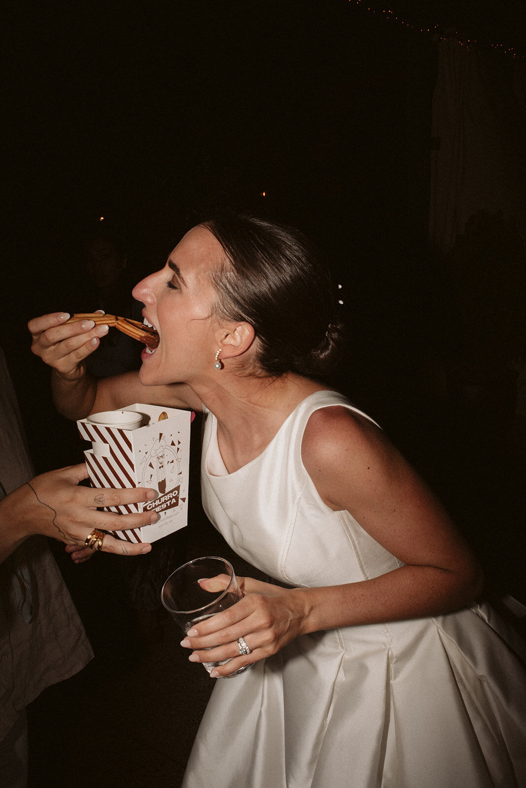The bride enjoying some chocolate with churros