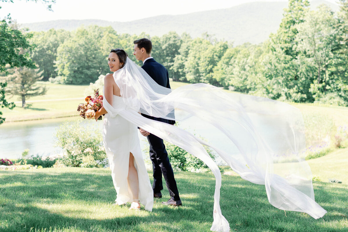 wedding dress in the wind on green hilltop