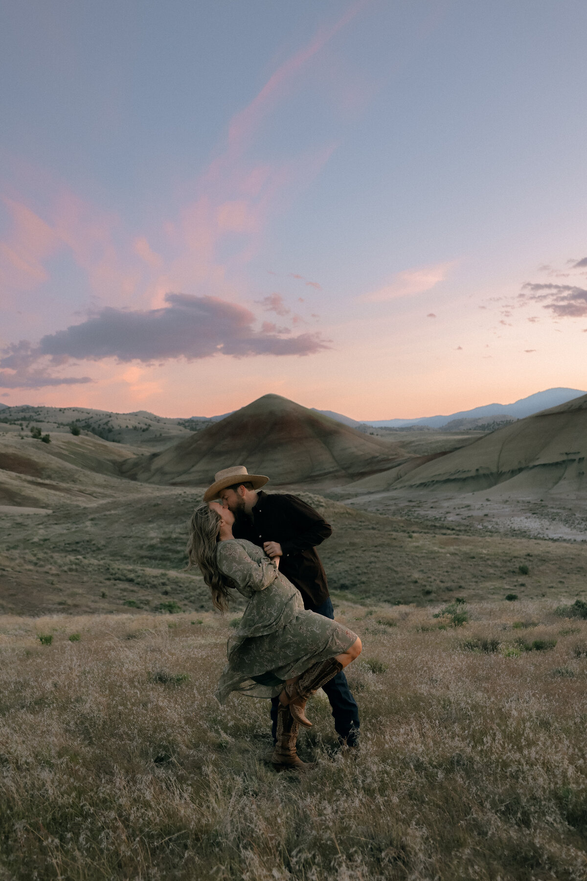 Romantic Western Engagement Photo at Painted Hills During Sunset Glow