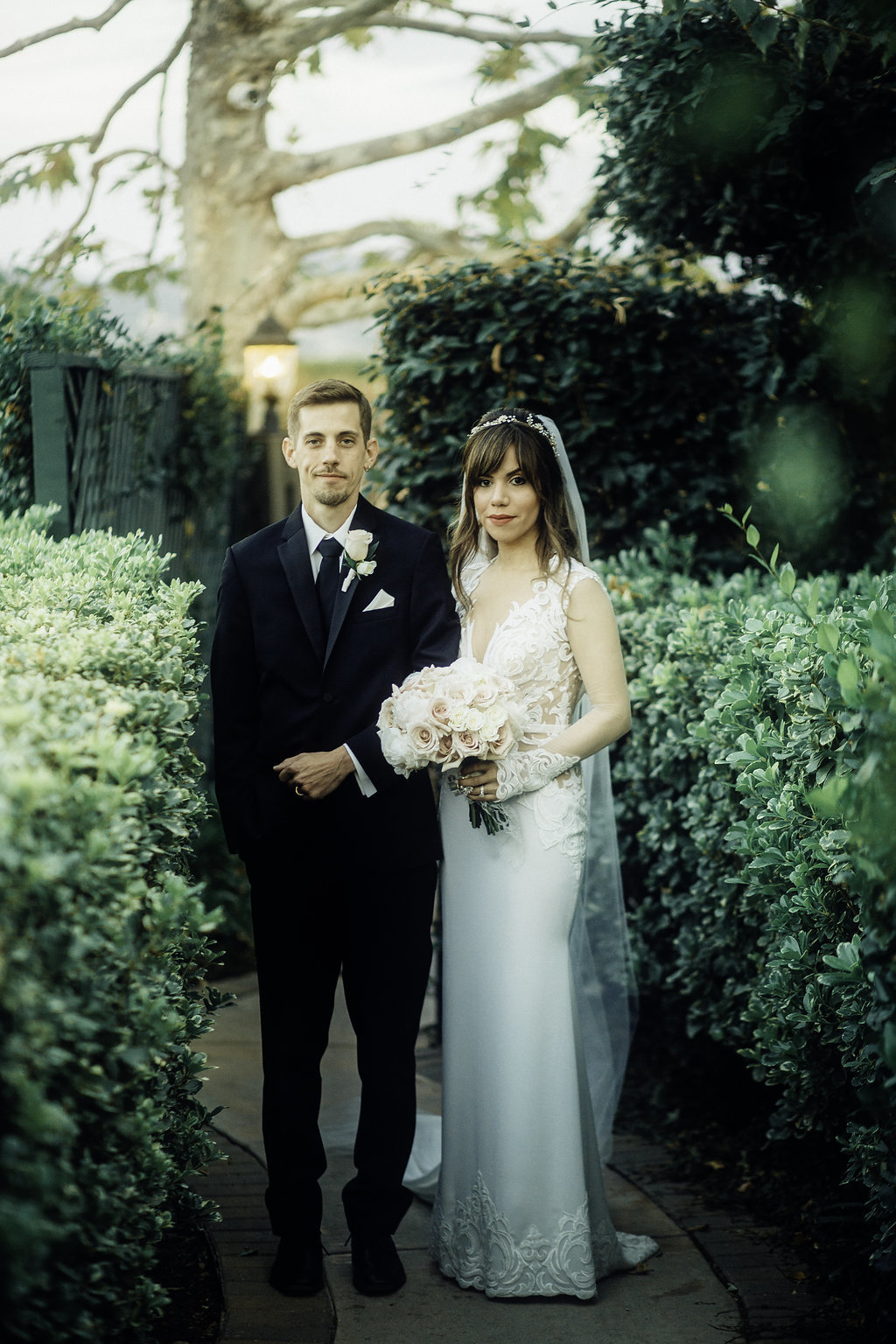 Wedding Photograph Of Bride Carrying a Bouquet Beside Her Groom Los Angeles
