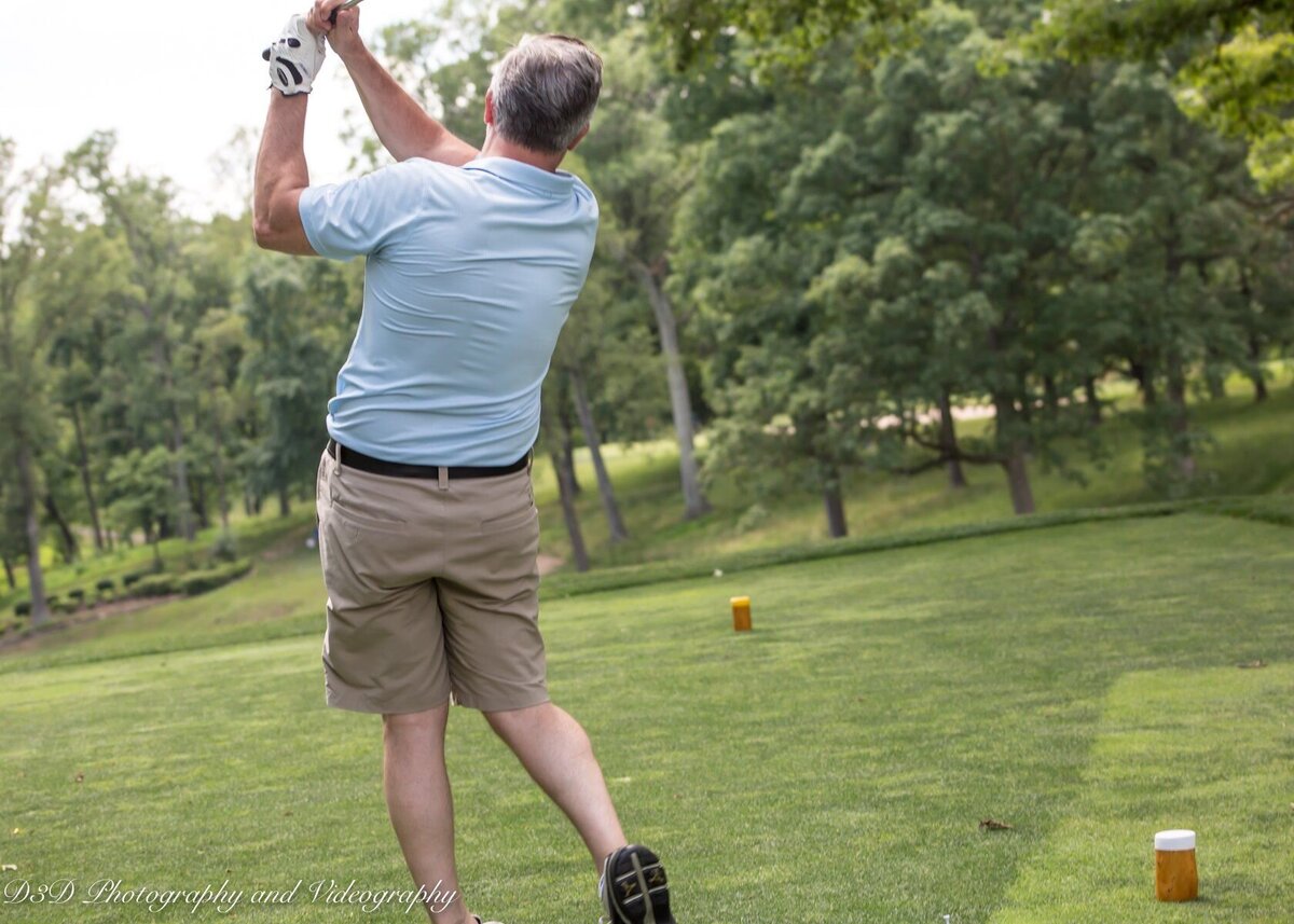 Professional golf event photography by D3D Photography showing golfer mid-swing on green course in DMV area