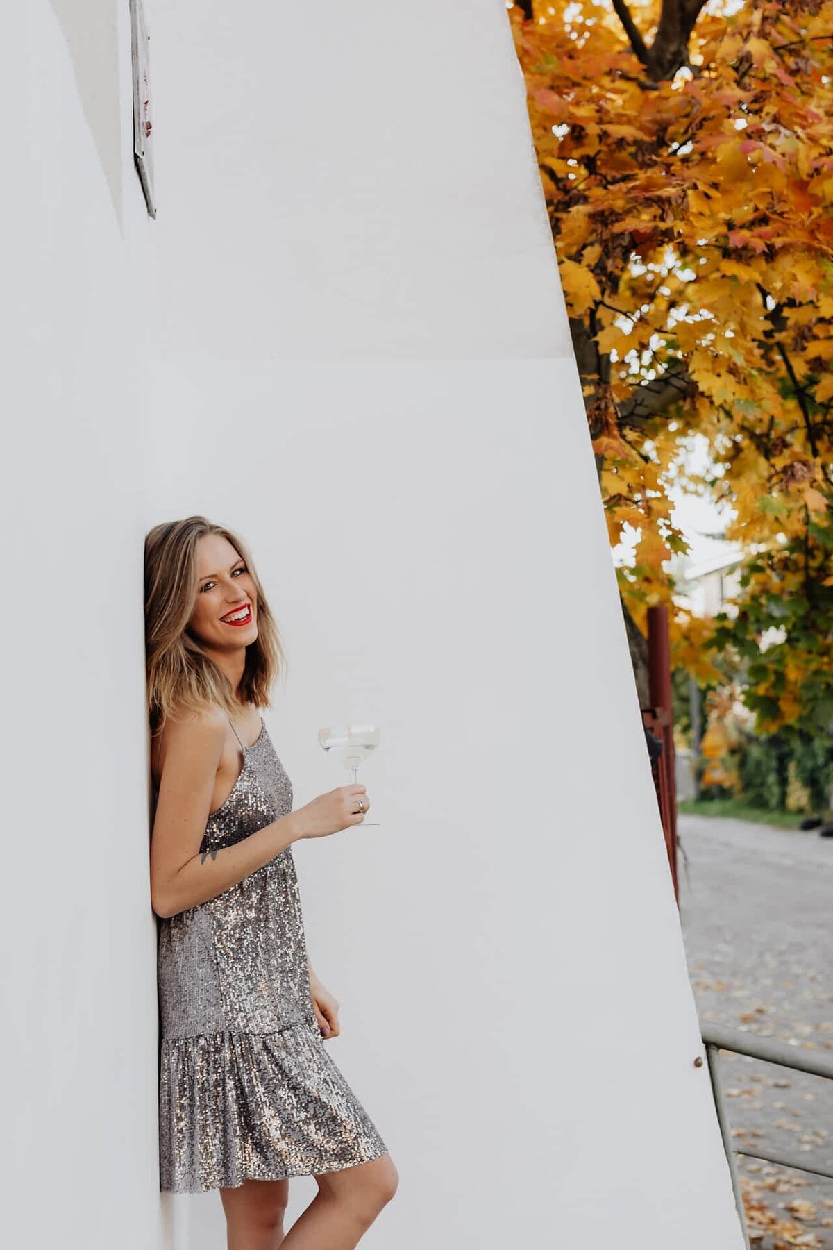 kaboompics_blond-woman-in-a-sequin-dress-is-holding-a-glass-of-champagne-14688-optimized