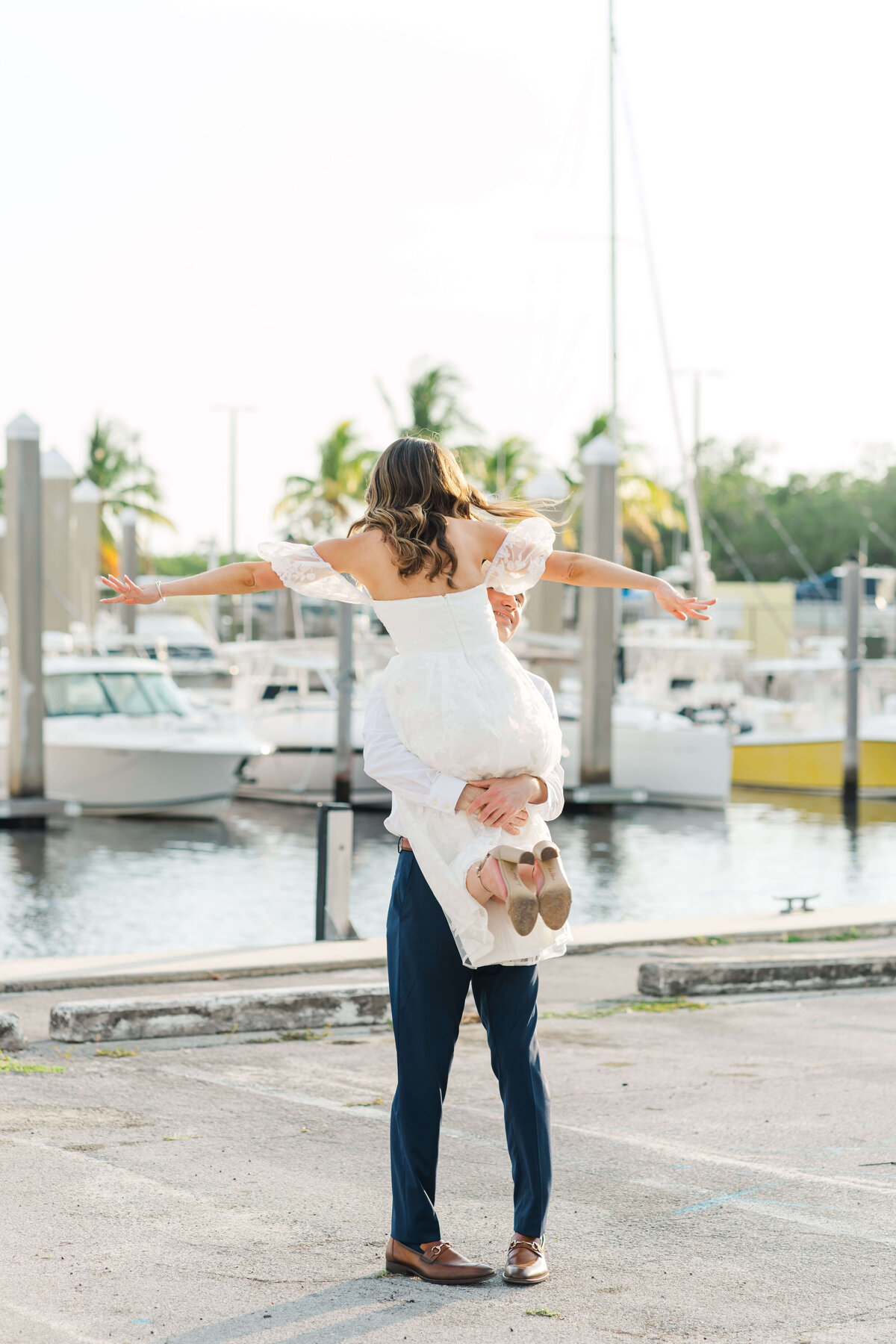 a man picking up a woman  on a marina