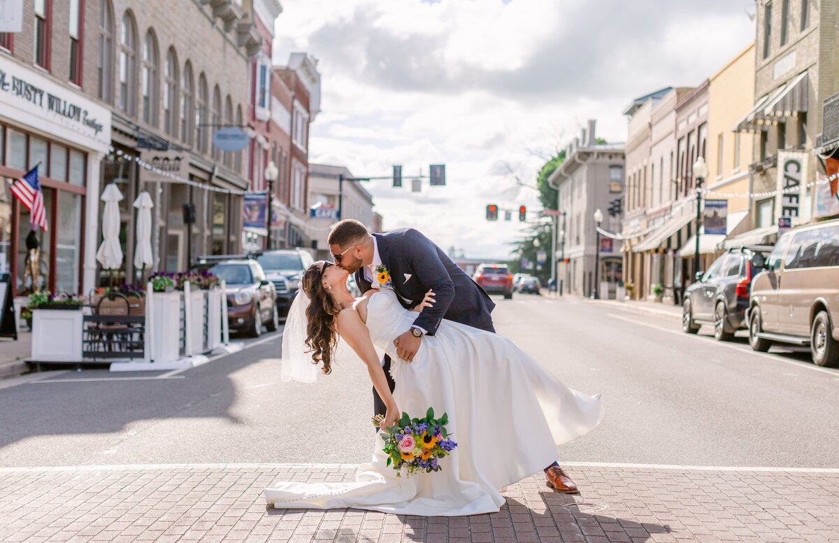 Groom dipping bride on East Davis Street in Culpeper, Virginia. Captured by Bethany Aubre Photography.