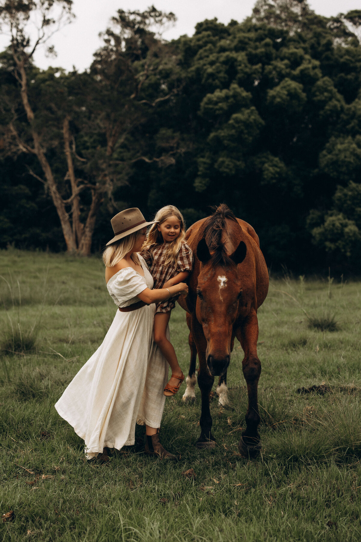 Mother-and-daughter-petting-horse