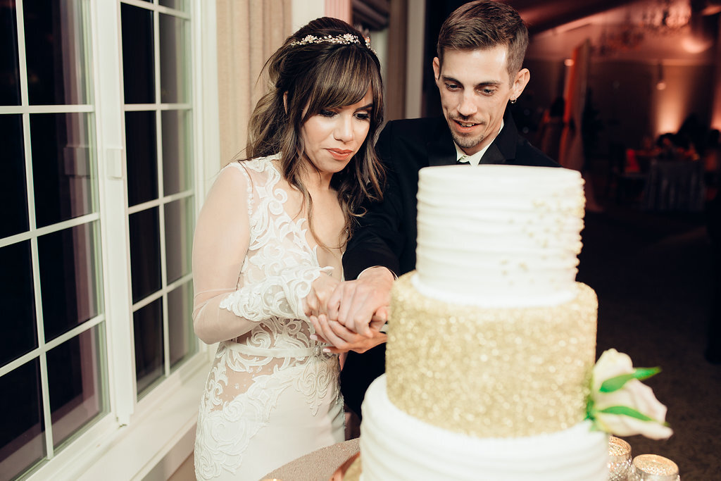 Wedding Photograph Of Bride And Groom Slicing The Wedding Cake Los Angeles