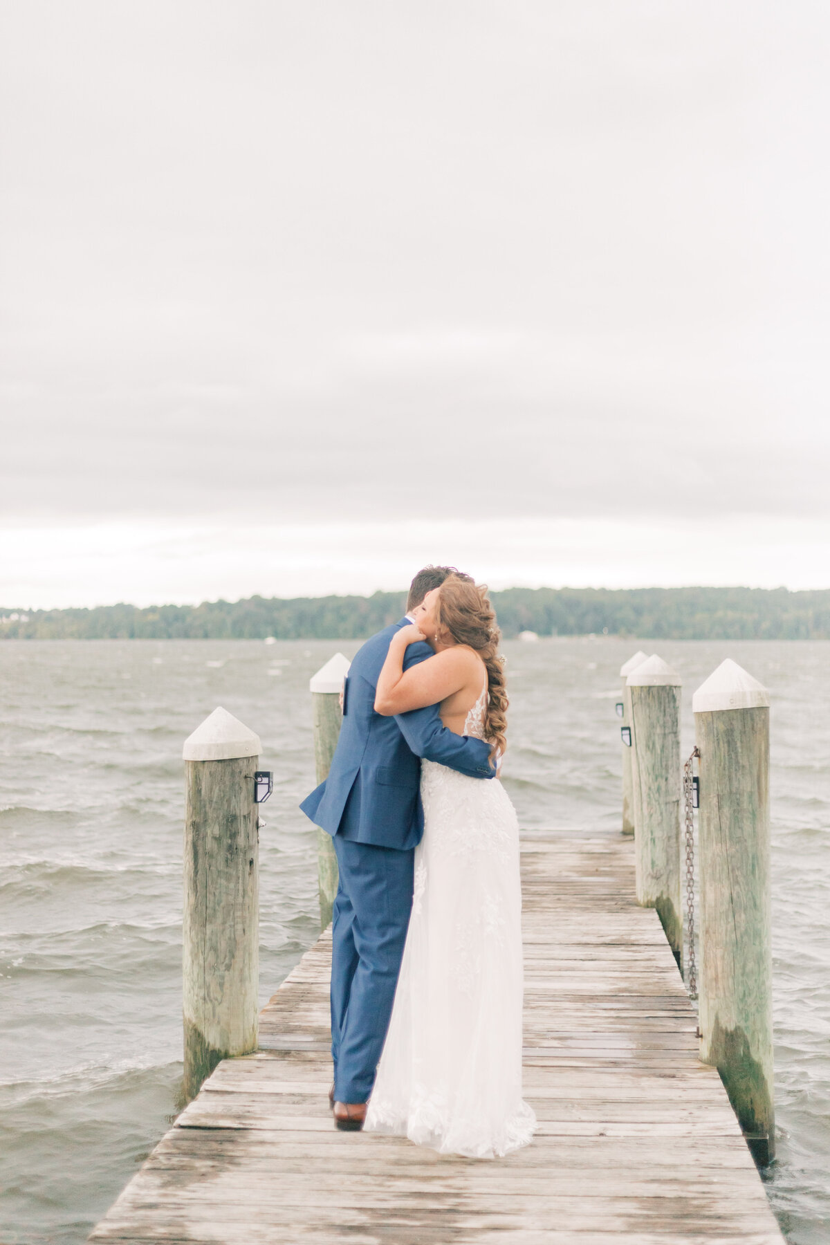 Maryland couple sharing their intimate first look on a dock, surrounded by water and nature on their wedding day.