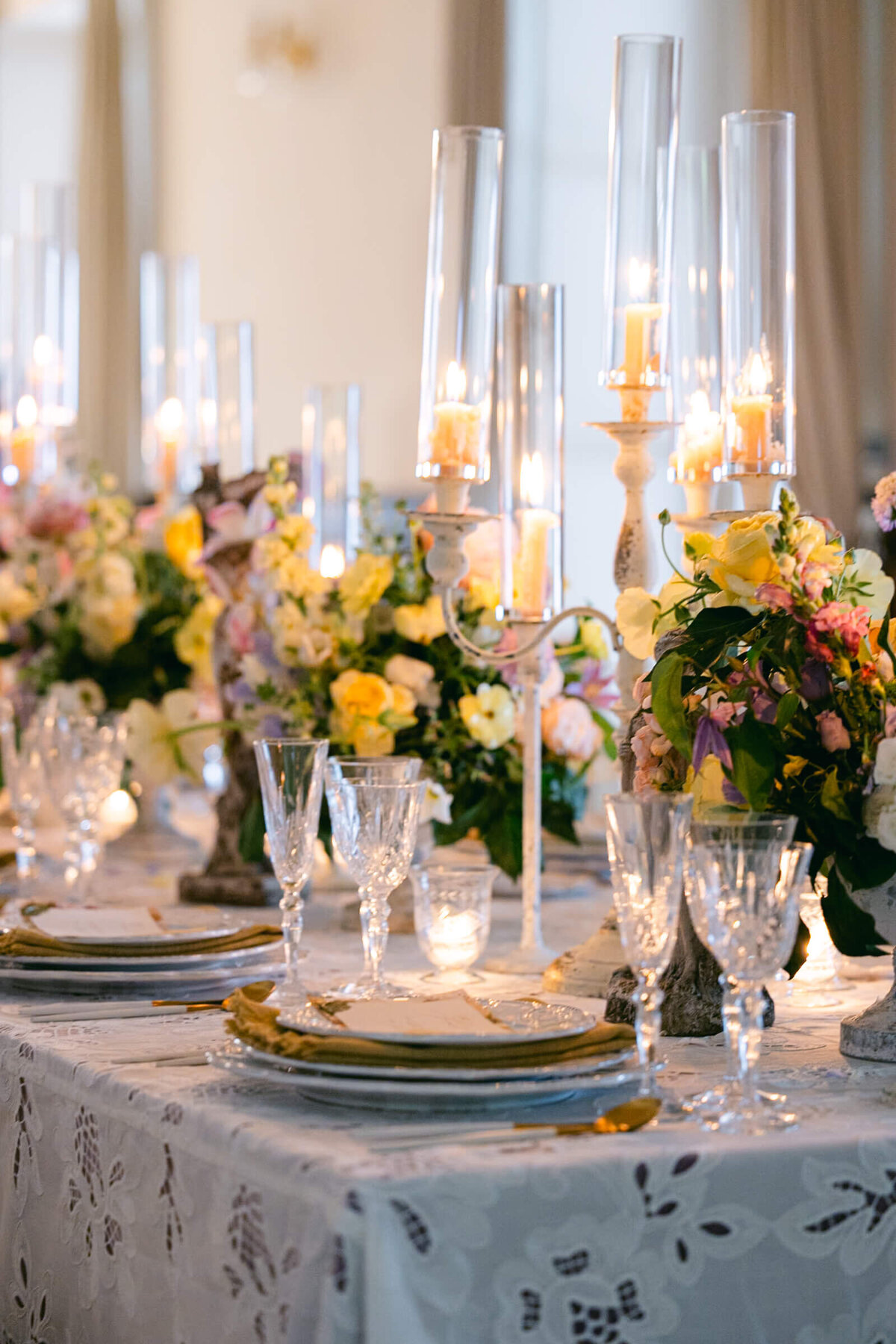 A wedding day photo of the reception cable covered in linens and candles at the wedding venue Villa Aura del Lago on Lake Como in Italy