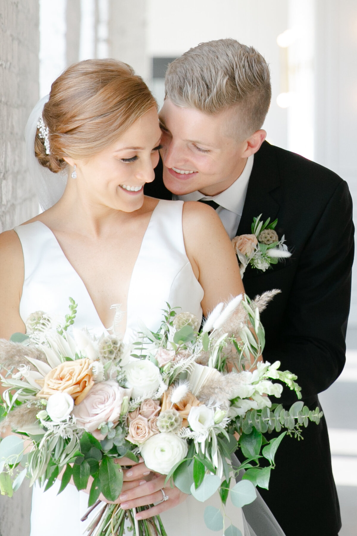 a couple pose for their wedding photos near a window in Ohio