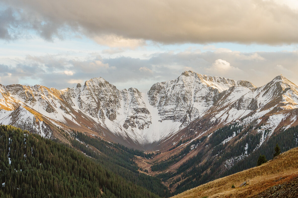 Photograph of a wide view looking down across a Jeep trail and many mountains near Telluride, Colorado.