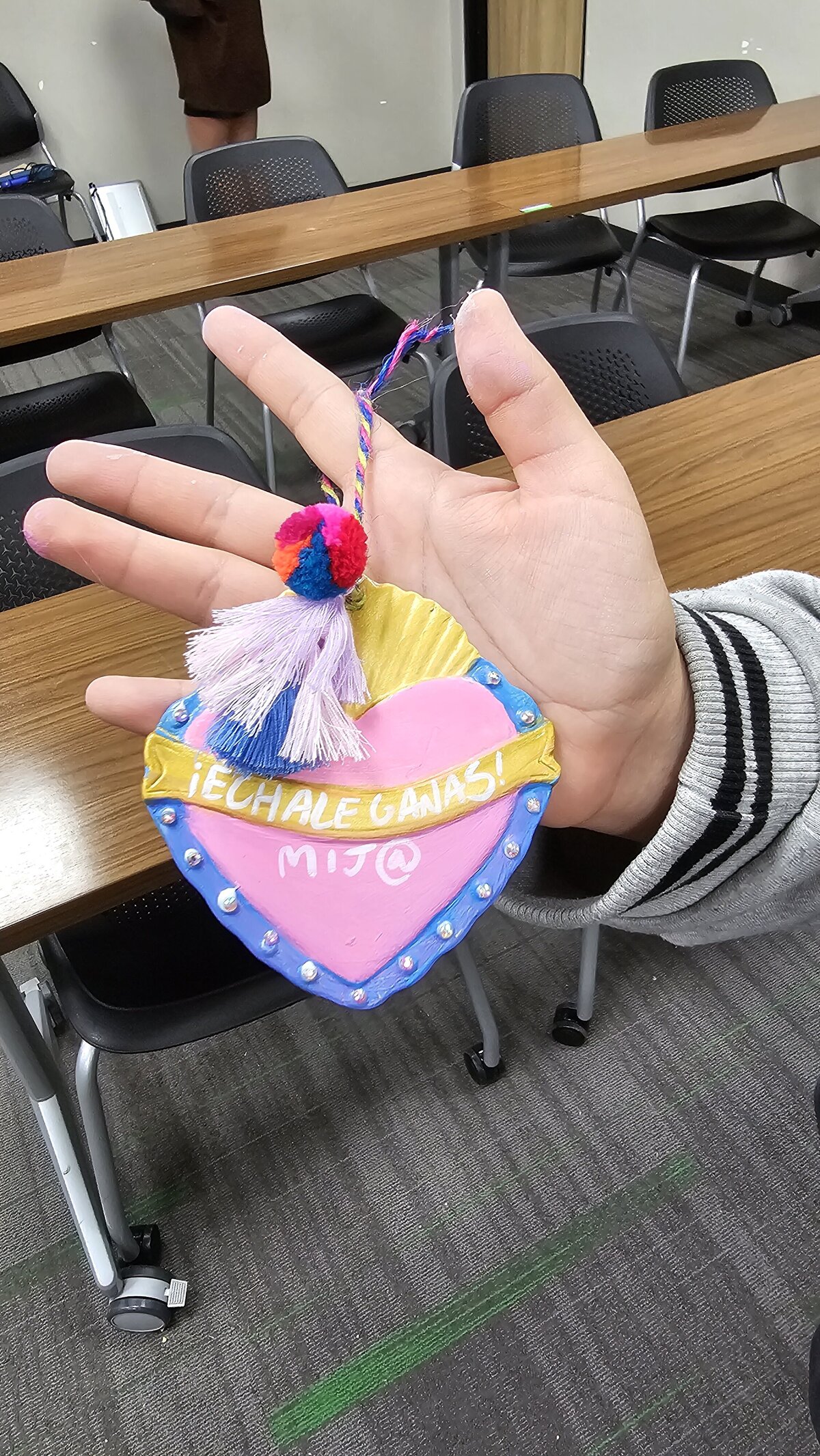The artistic triumph as a workshop participant proudly presents their final masterpiece—a colorful heart adorned with an inspirational phrase. Tthe materials that brought this creation to life at Soleil Vida Studio.