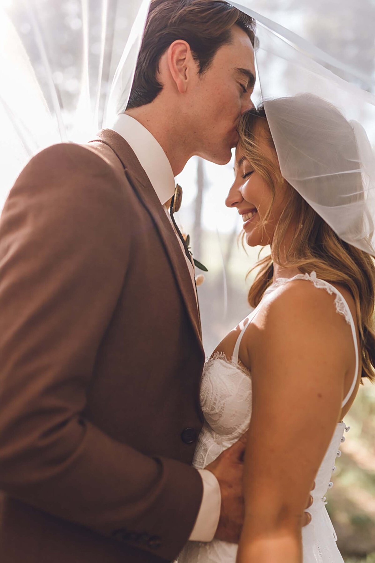 Husband kissing wife on the forehead