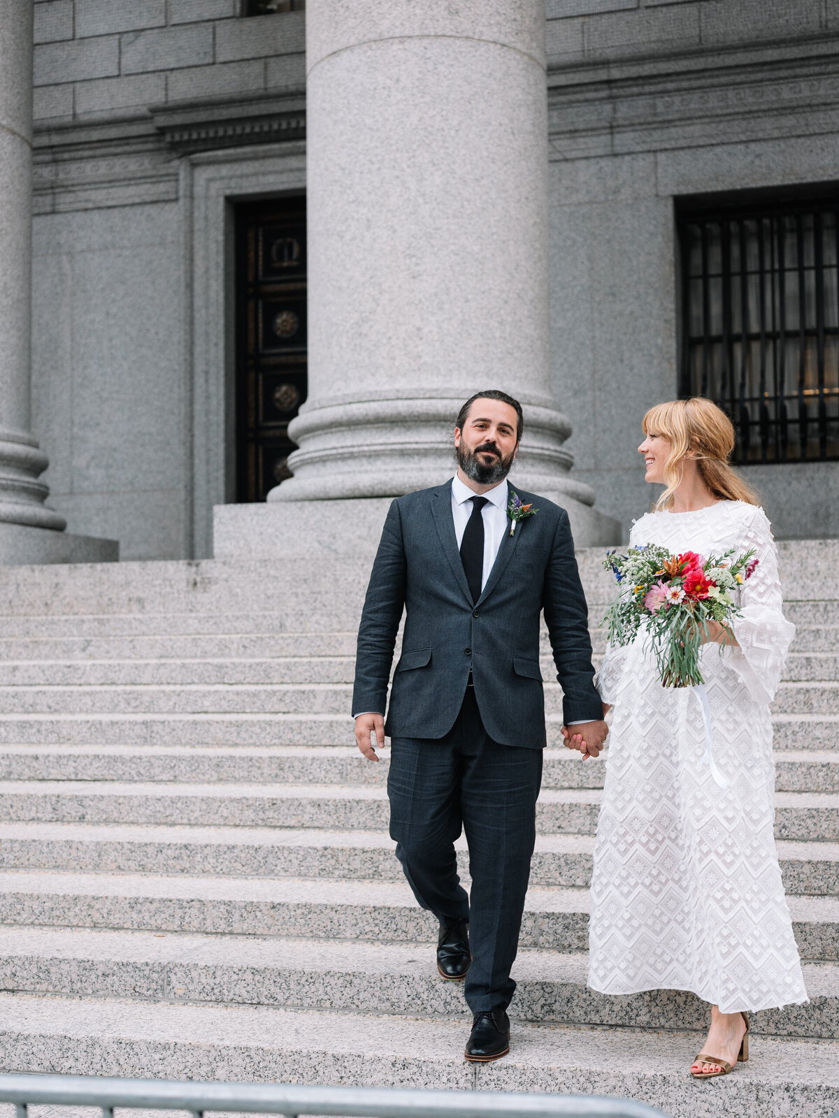 newlyweds walk down stairs