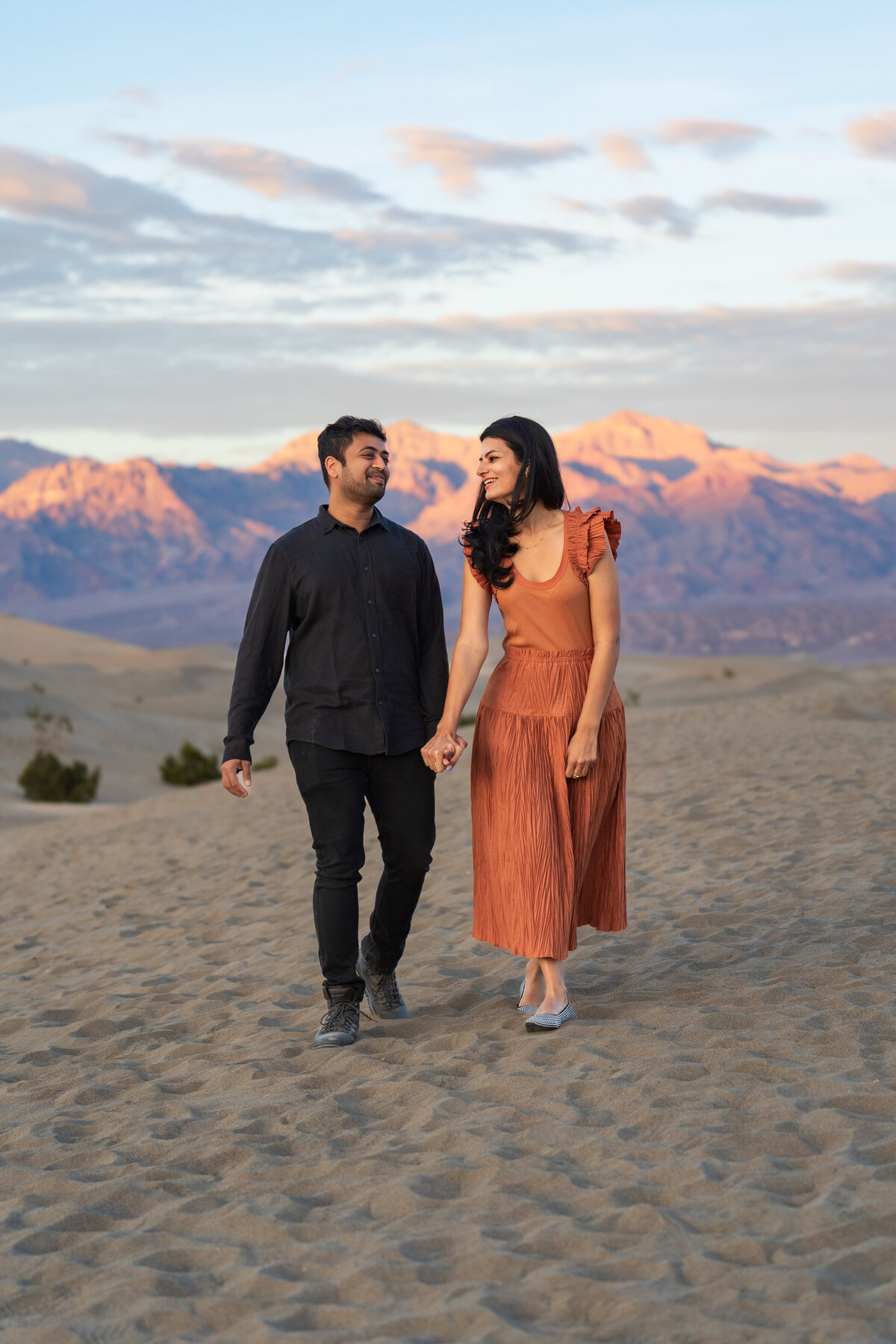 A couple walking in the sand together