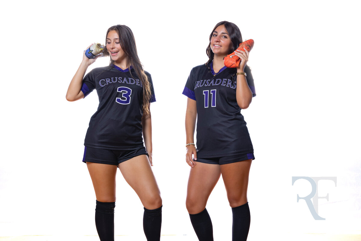 Photographer in Avon | Rob Faber Photography | Two Crusaders soccer players holding cleats to their ears like phones, smiling and playful during Media Day.