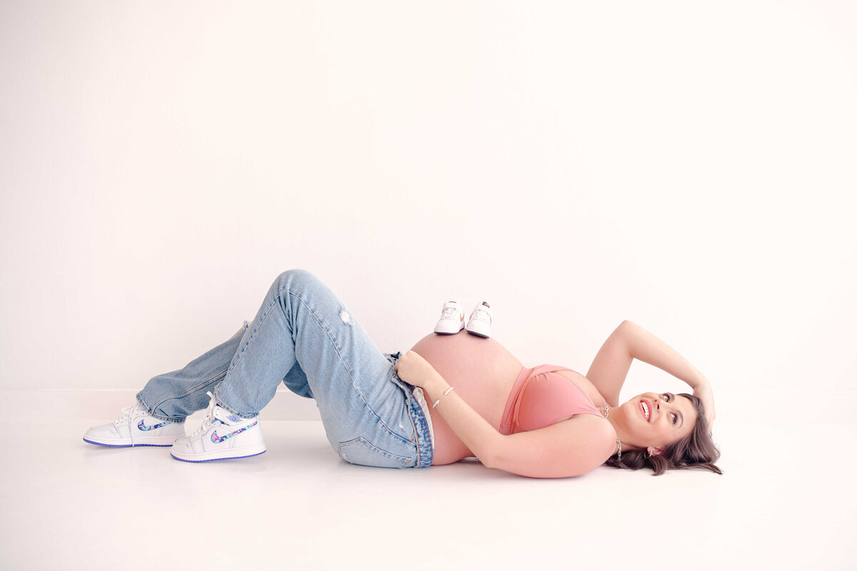 Courtney posing with matching Jordan's for her studio maternity session.