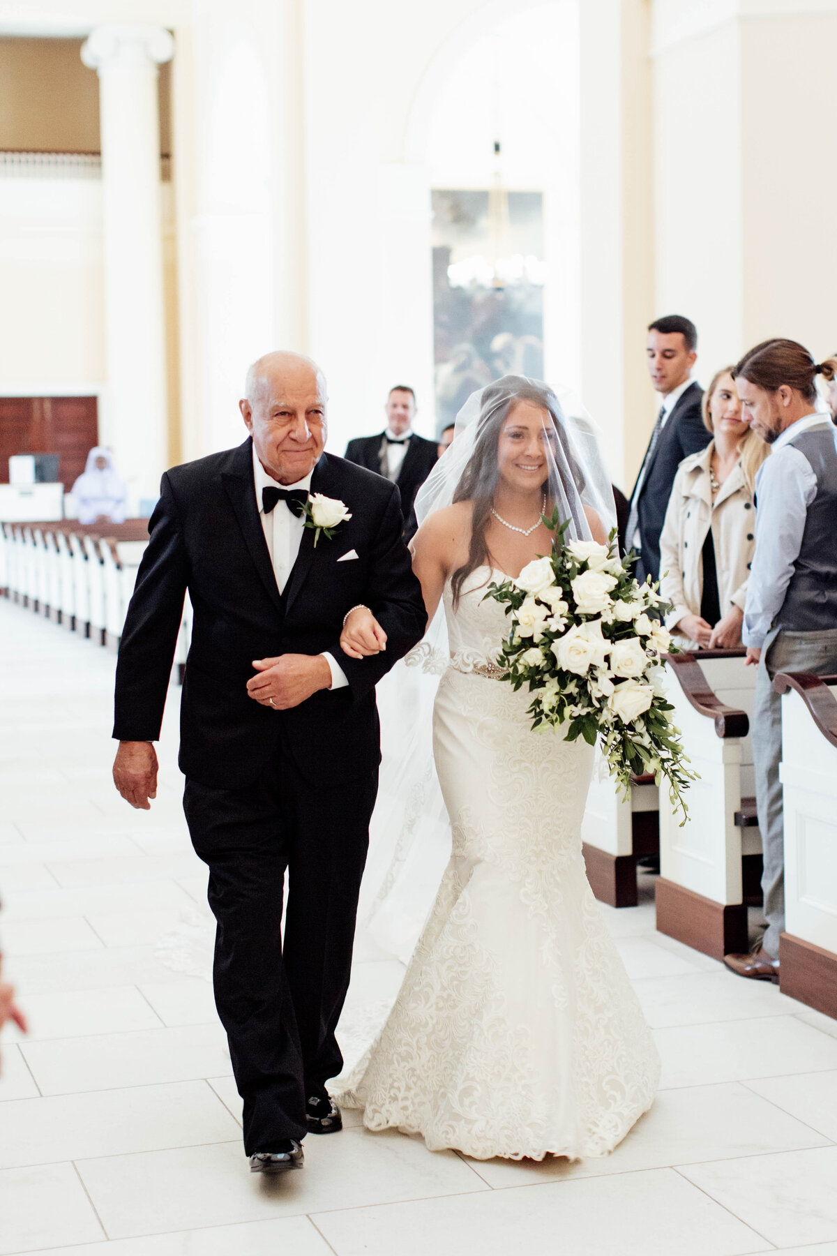 Father of bride walking down aisle with bride.