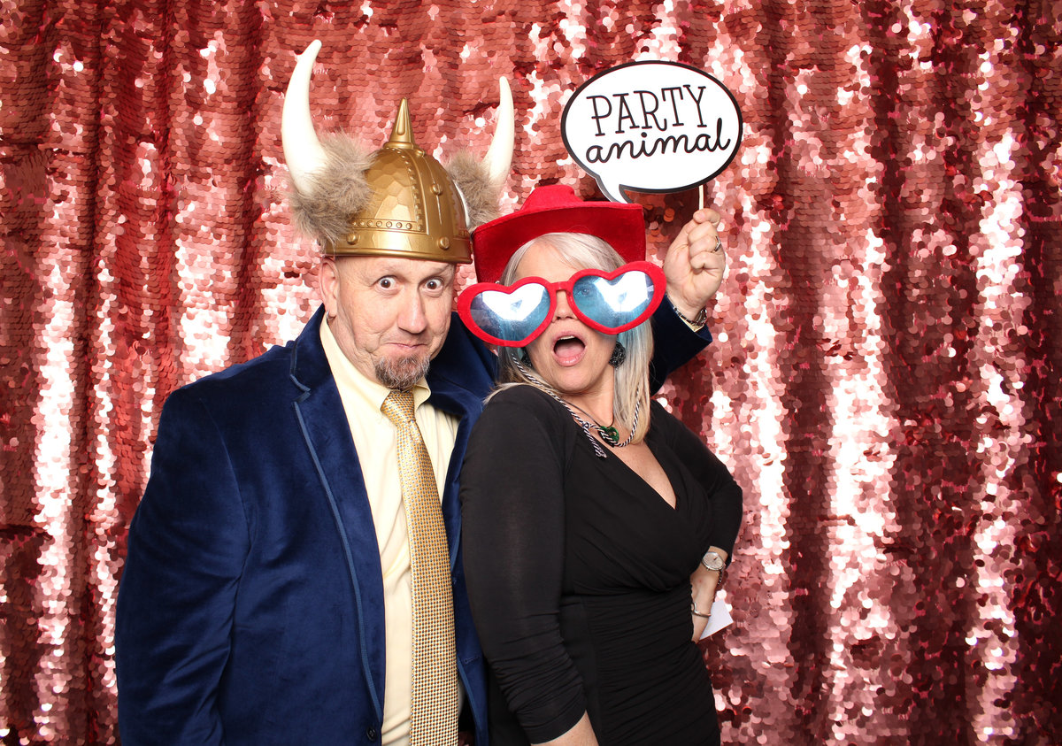 Man and Woman get silly together in a photo booth rental