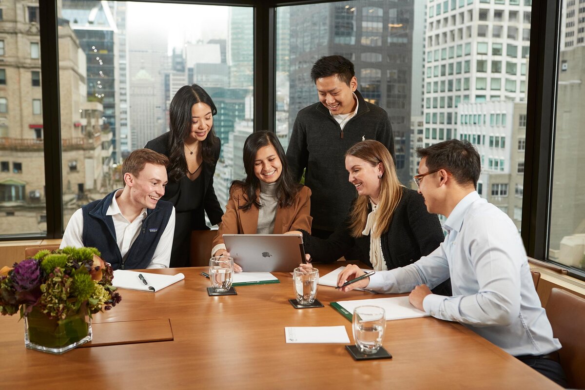 Team engaged in a strategic planning session in the conference room at Cornell Capital Offices, highlighting teamwork and focus, captured by Ylva Erevall.