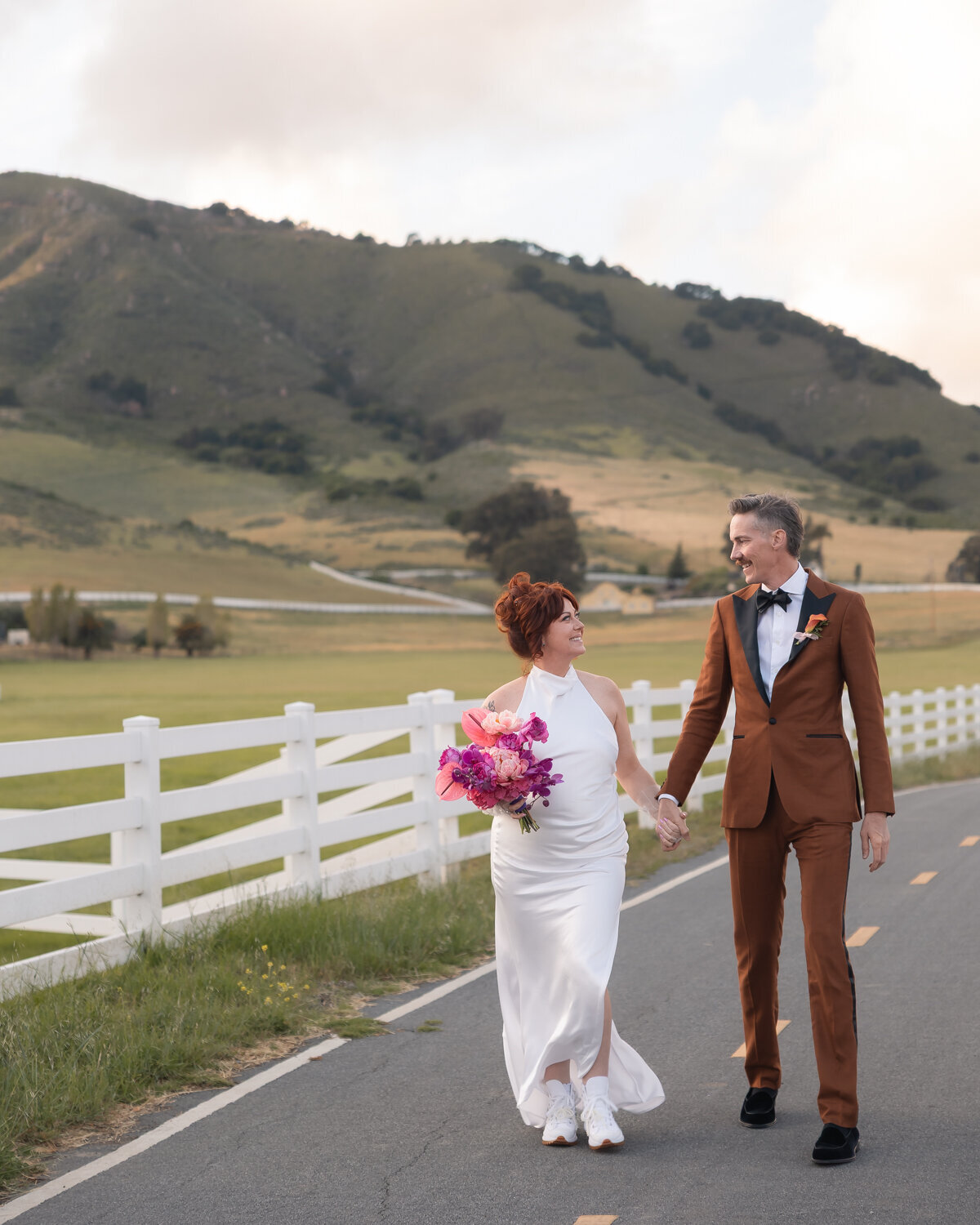 Madonna Inn wedding couples photos with colorful flower bouquet during sunset photos in San Luis Obispo