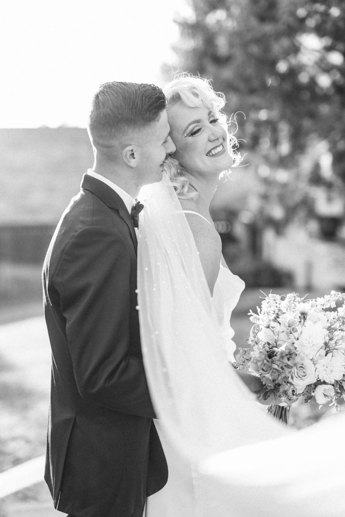 groom-laughing-into-brides-ear