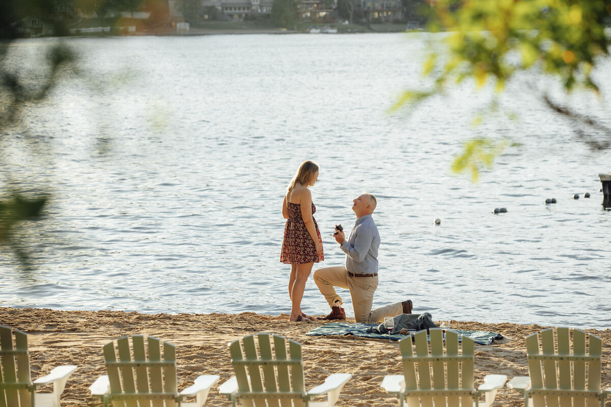 Proposal Photography | Groom-to-be proposing on the beach at Lake Sparta during sunset | Sparta, New Jersey
