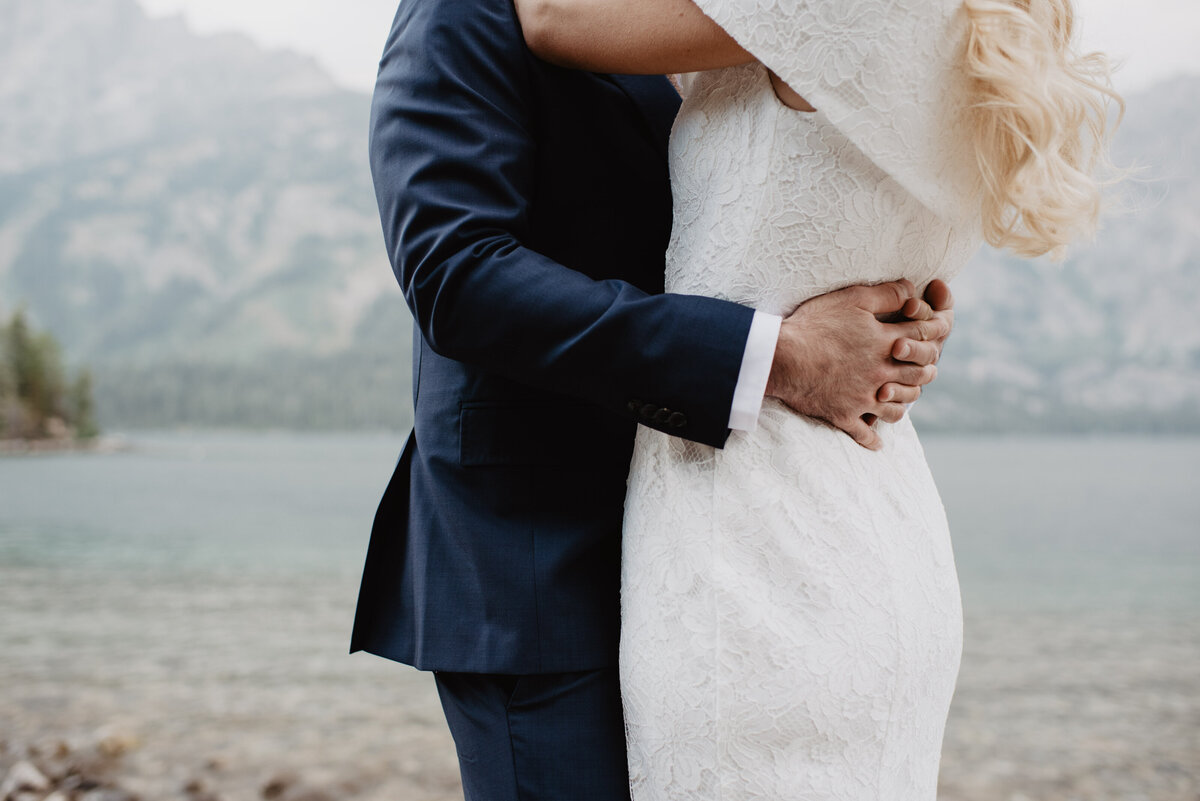 Photographers Jackson Hole capture groom holding bride's waist