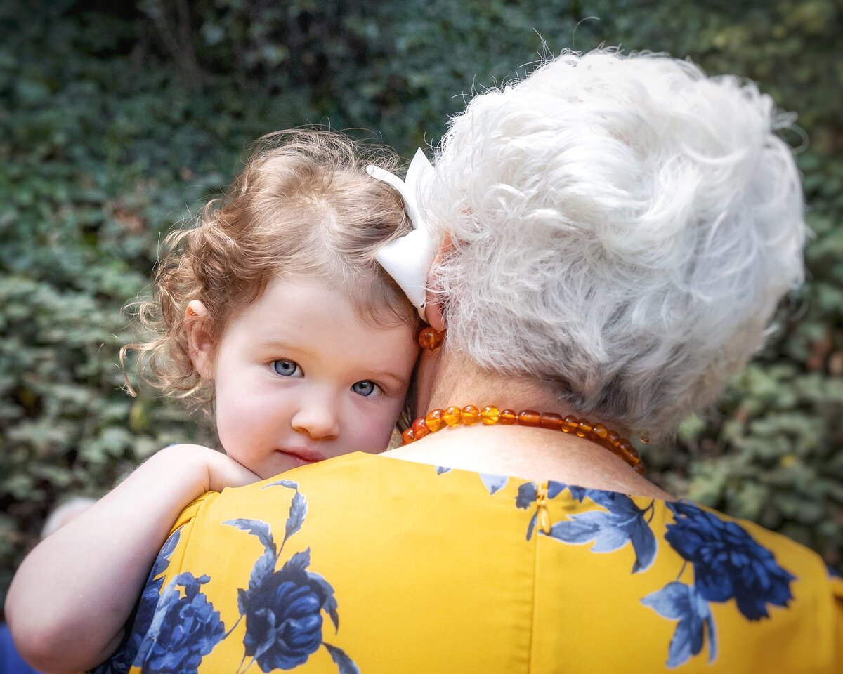 Child hugs her grandmother