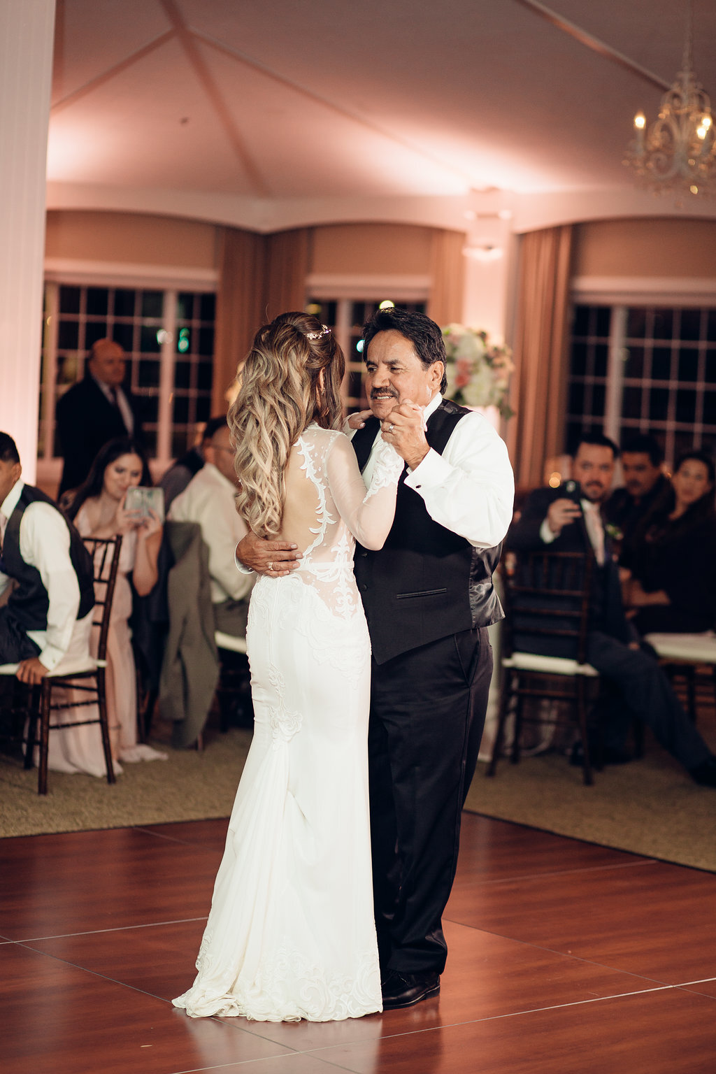 Wedding Photograph Of Visitors Looking At The Bride And Man In Black Suit Dancing Los Angeles