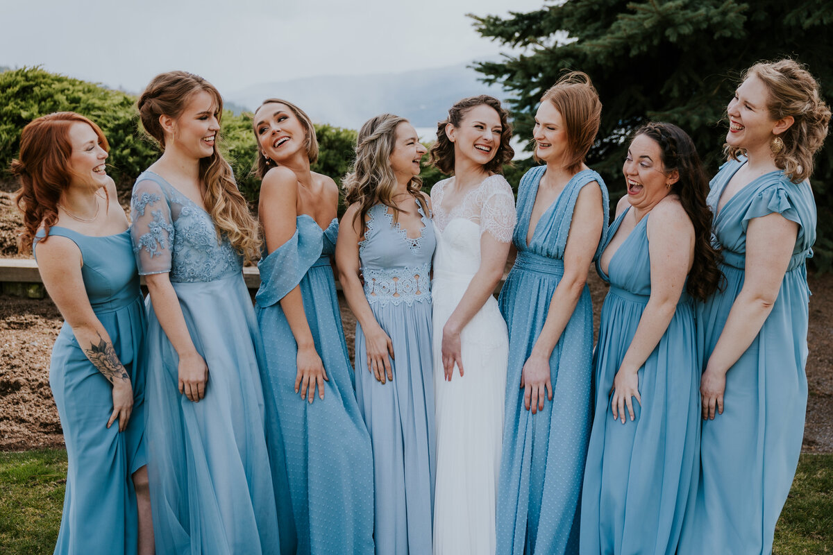 Bride giggles with bridesmaids at Coeur d'Alene golf course.