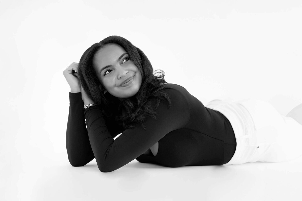 high-school-senior-girl-laying-in-studio