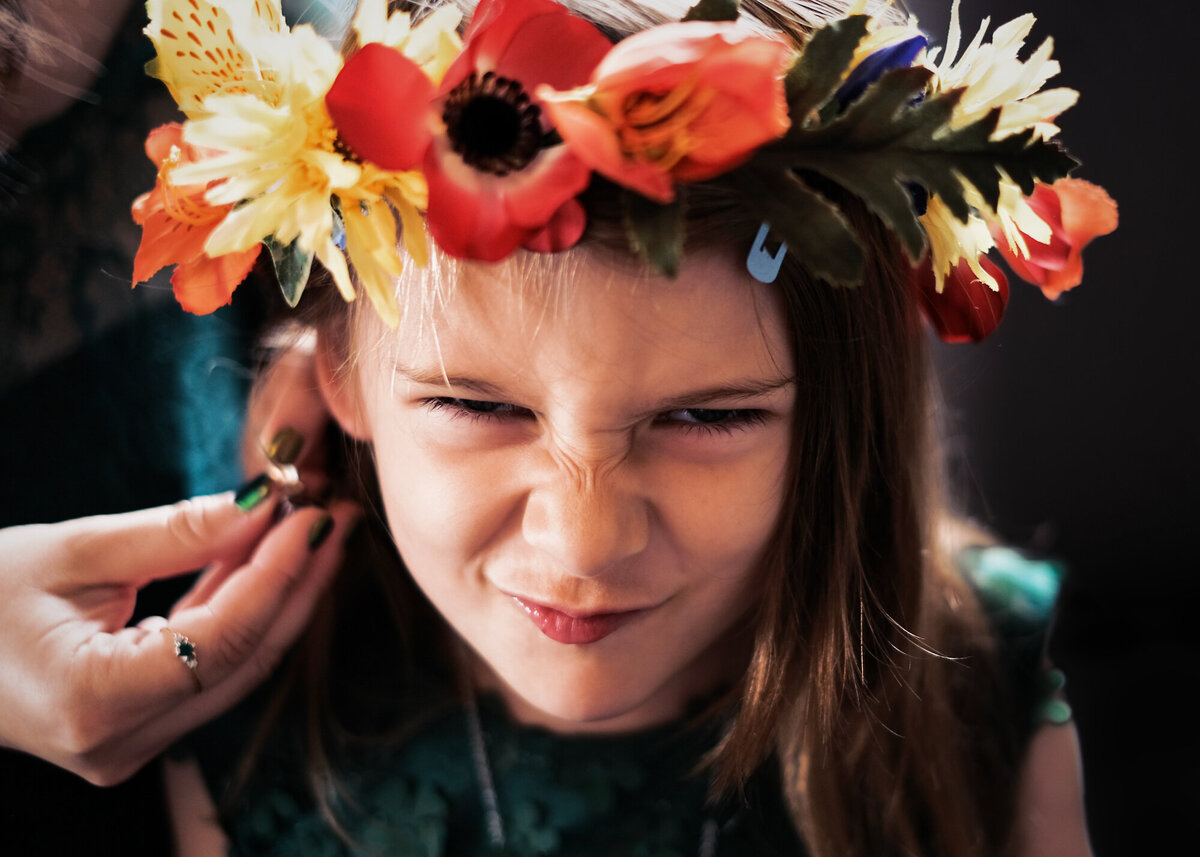 Cheeky girl pulling a face at a wedding