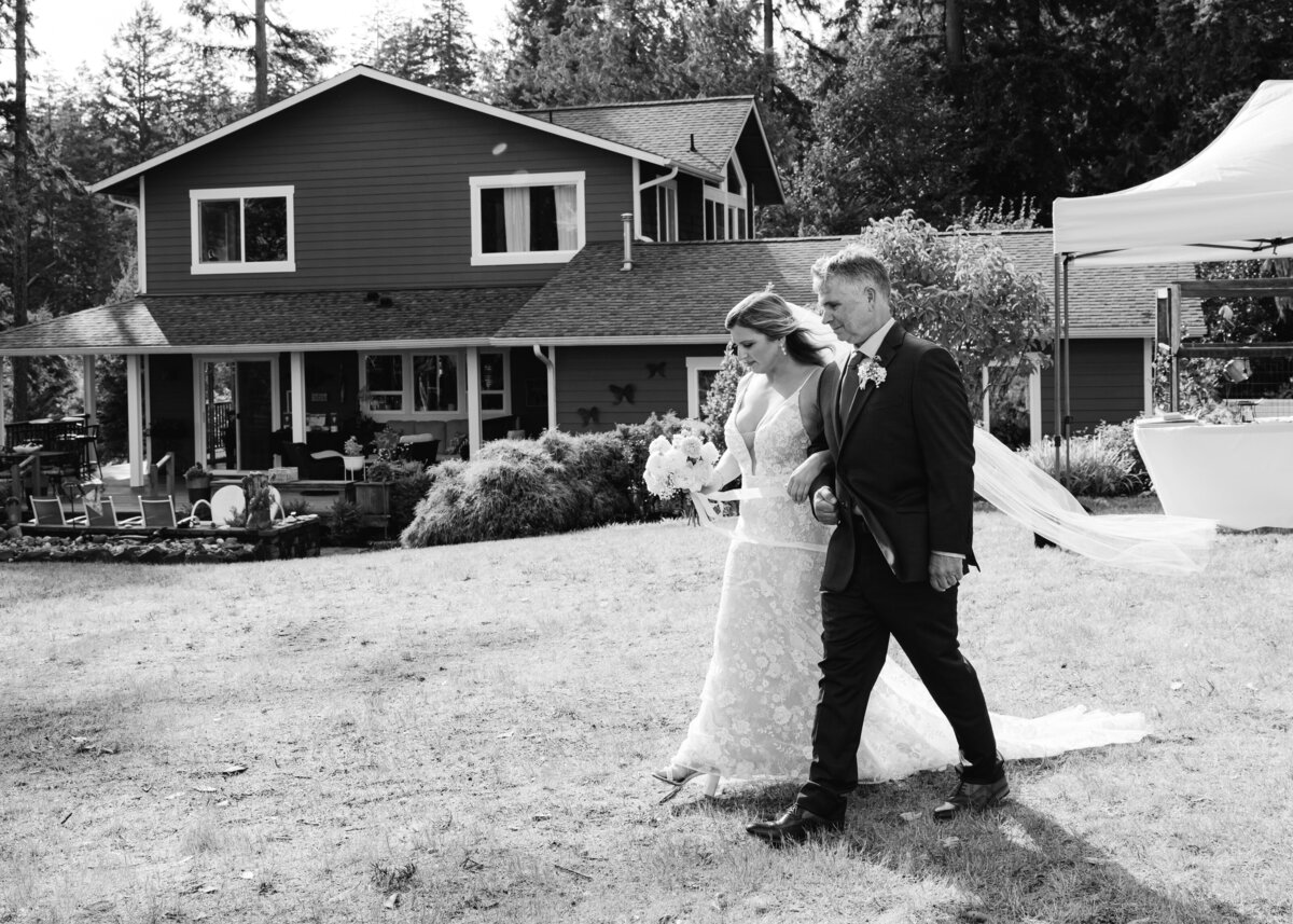 bride and father walk down aisle outdoor wedding