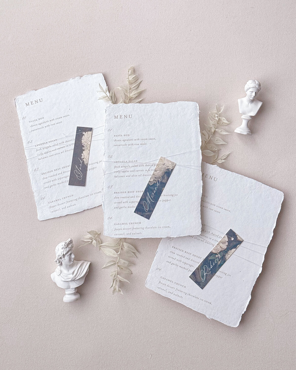 Handmade paper wedding menu with antique floral place card and white thread