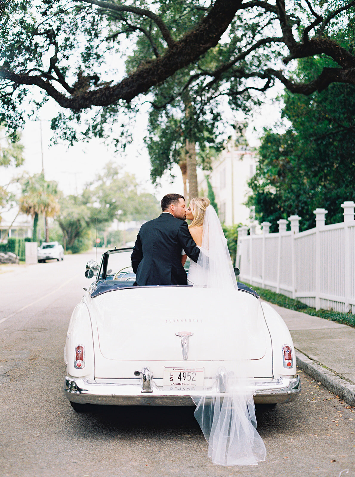 vintage_white_car_thomas_bennett_house_fall_wedding_bride_groom_sitting_in_back_kailee_dimeglio_photography-135_websize