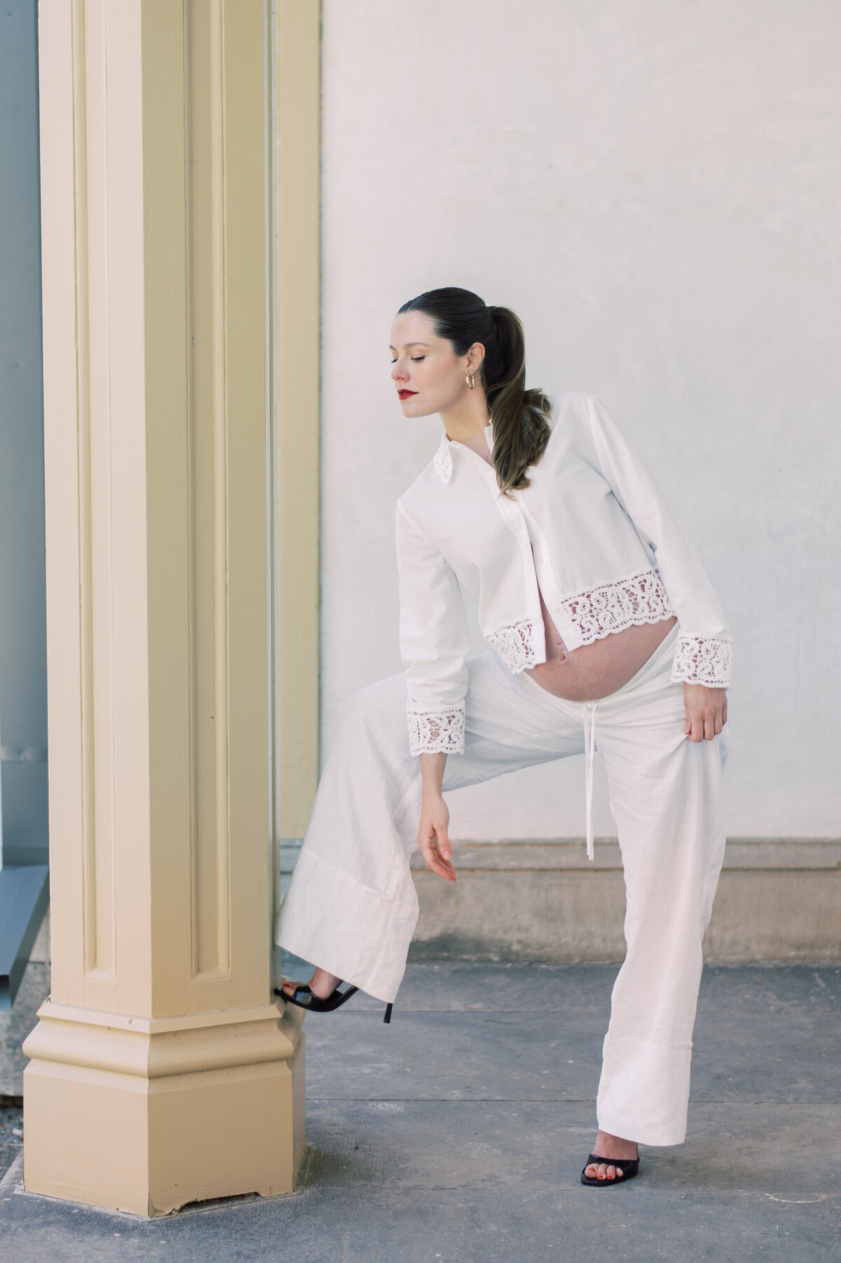 Cropped black-and-white maternity image highlighting a strong stance and serene expression in lace-trimmed Zara
