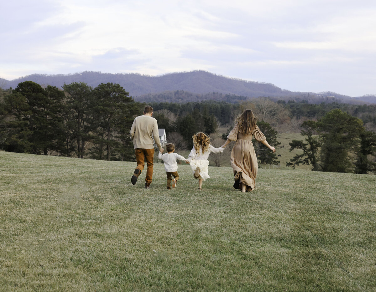 Family running down a mountain in Asheville