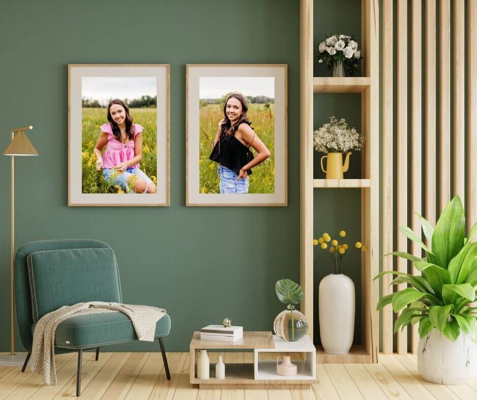 two framed and matted photos of a Neenah high school senior hanging on a teal wall in a living room.