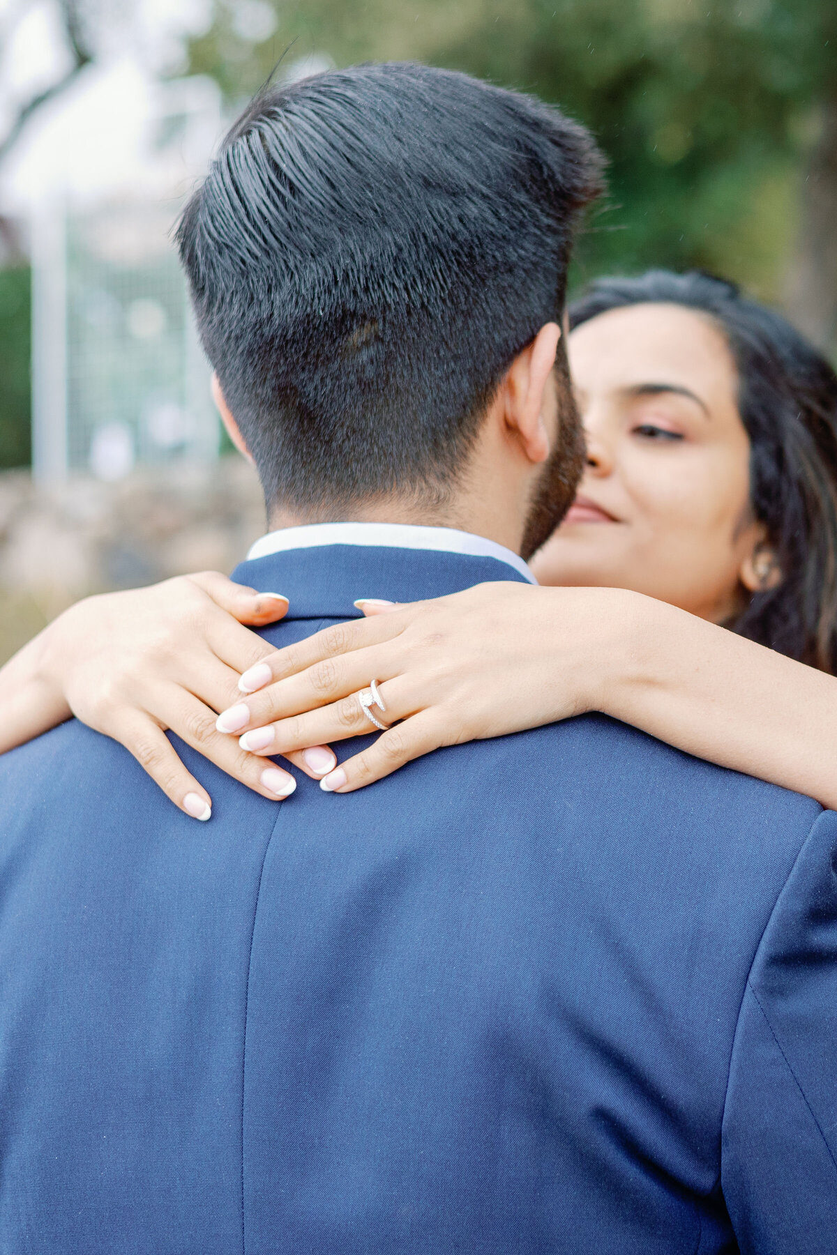 bay area photographers photographs bride holding her hands on her fiances neck and she looks up to kiss him