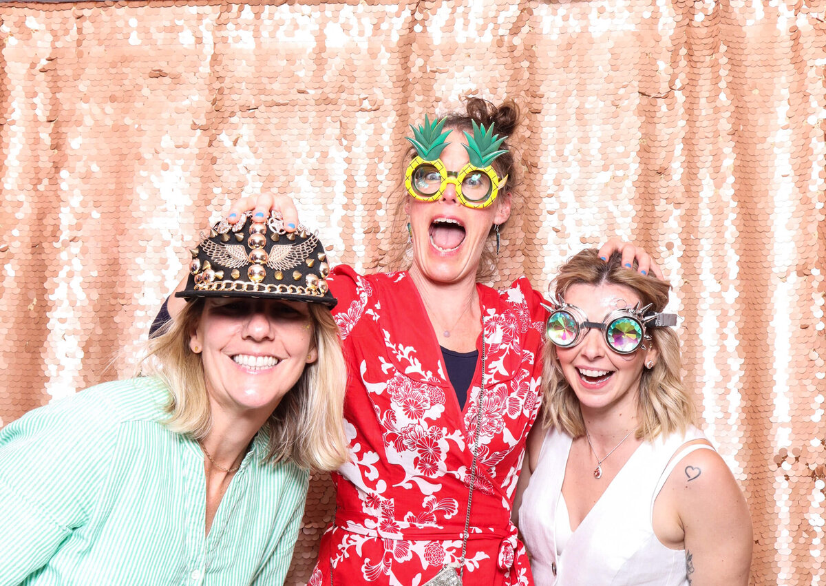 fun photo with 3 guests posing against a blush sequins backdrop for a themed birthday party photo rental
