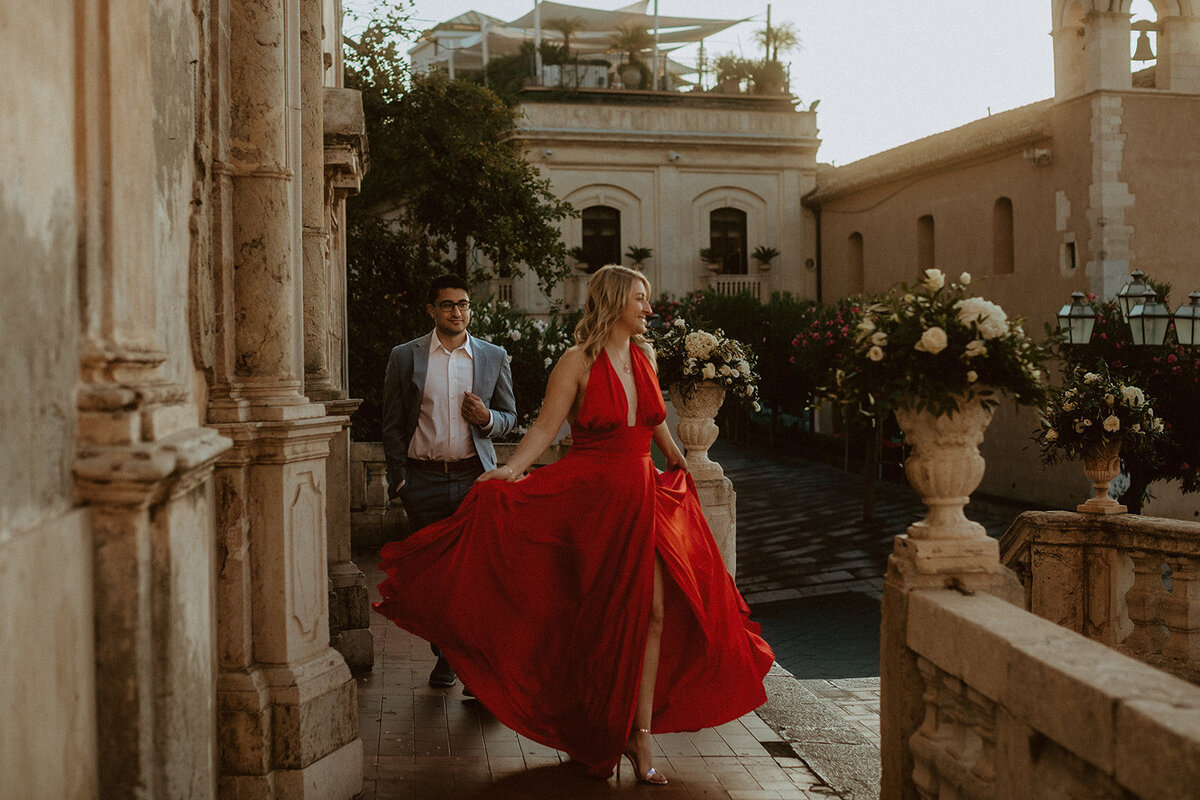woman wears red dress in taormina italy