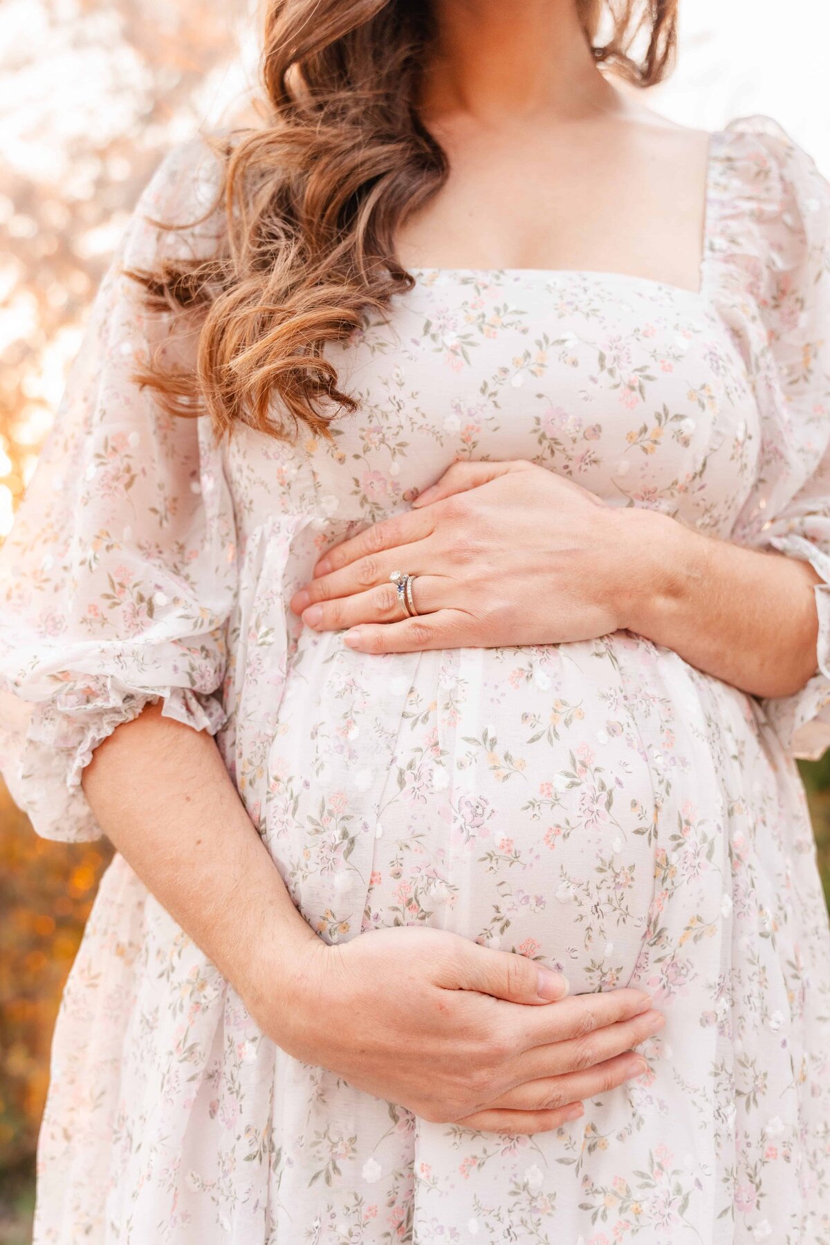 Close up of mother's baby bump during spring maternity photography session